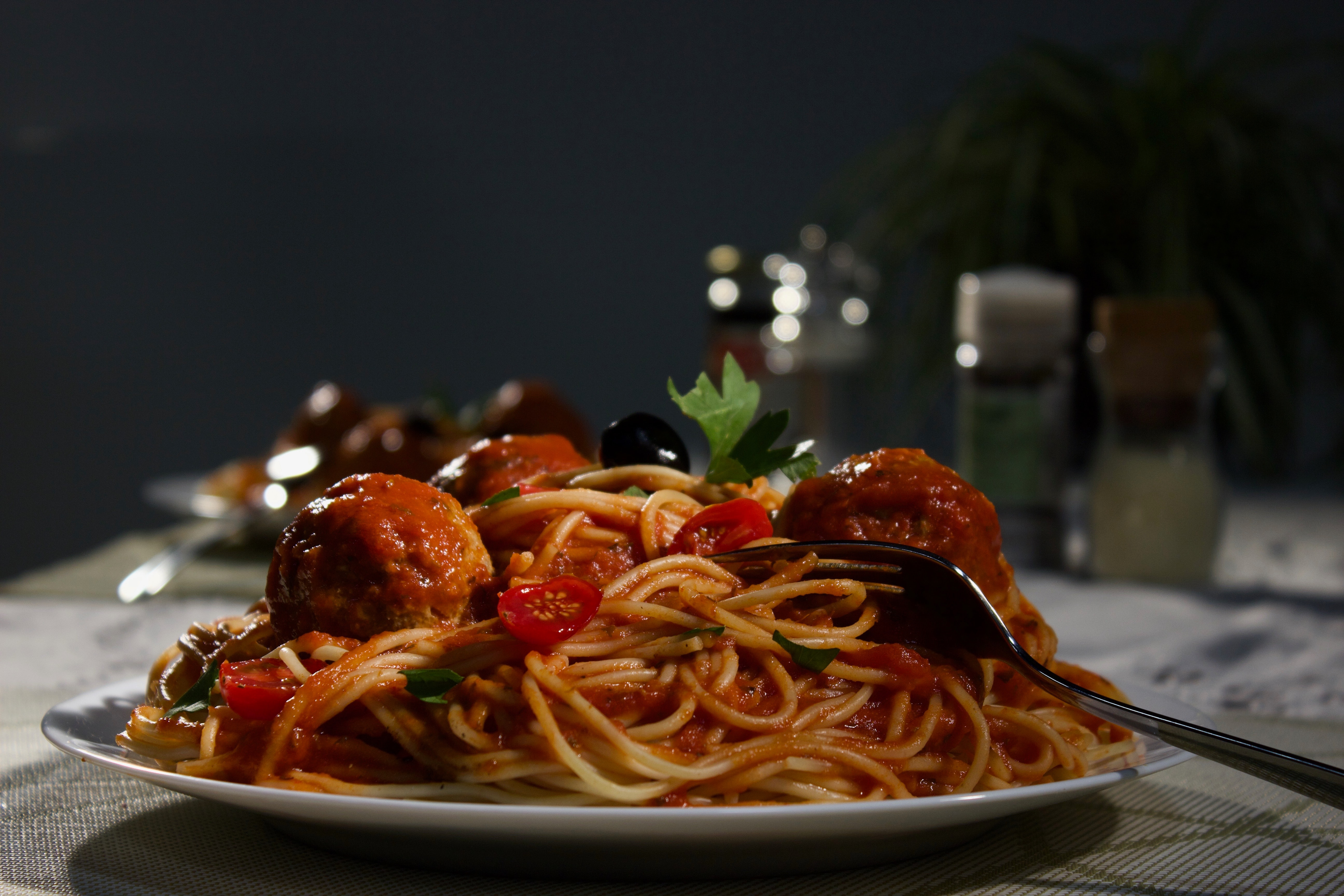 A plate of spaghetti with meatballs.